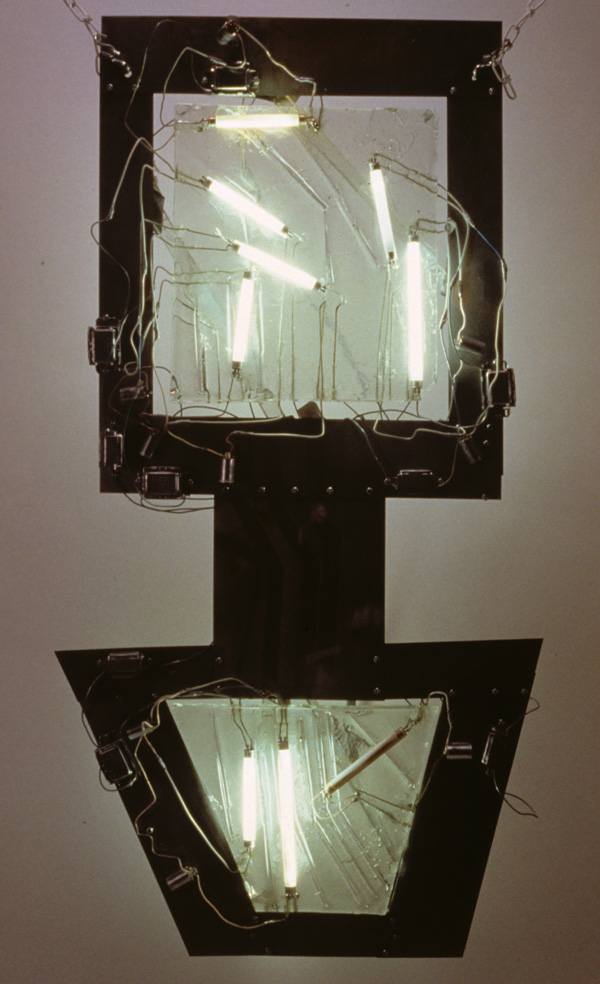 Techno-Virus

stainless steel, cast glass, fourescent bulbs, nichrome wire embedded-into-cast glass, light ballast, flourescent light starters

H. 54″  W. 28″  D. 4″